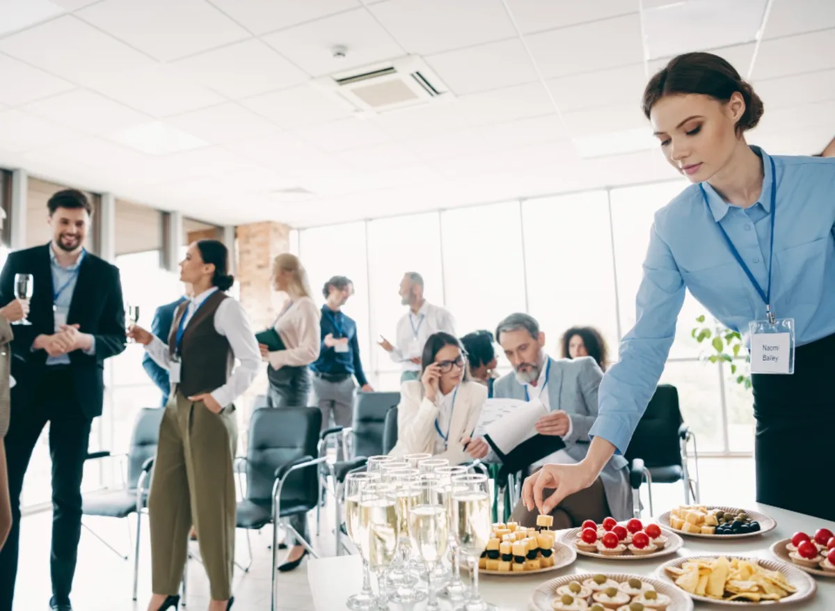 Woman using laptop connected to external hard drive.